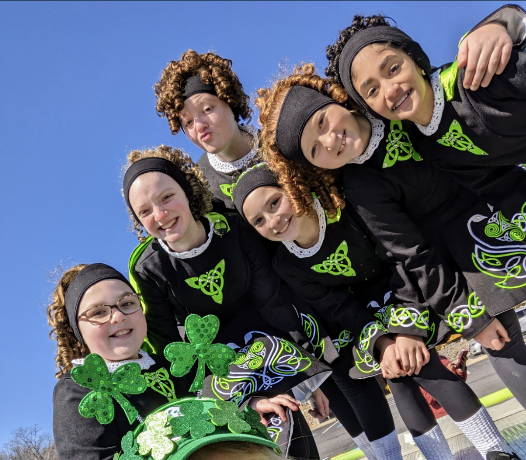 Irish dance group at festival with traditional costumes and Celtic designs